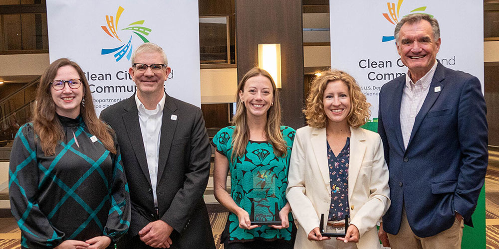 a group of people holding awards on a stage