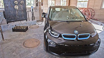 A photo of an electric BMW plugged in at the new charging station at Thomas Edison National Historical Park.