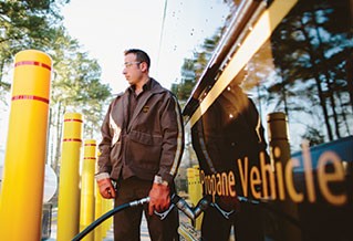 Photo of a man fueling a propane UPS vehicle