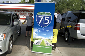 This photo shows two drivers fueling their vehicles with E85 along the I-75 Clean Fuels Corridor.