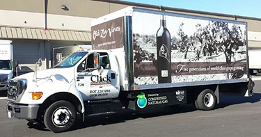 Photo of a white truck with a wine bottle on the side and the company's name, "Click" on the cab door.