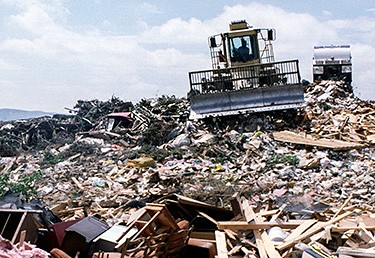 Photo of a garbage hauler in a dump.