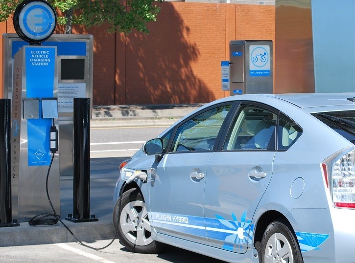 A photo of a plug-in hybrid electric vehicle at an electric vehicle charging station.